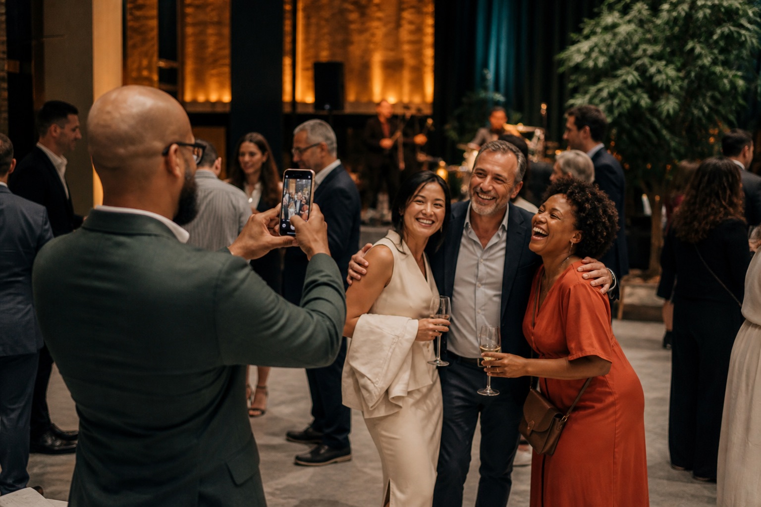 A guest using a phone to photograph friends at an event